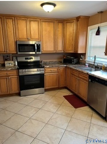3732 Birdwood Road Richmond, VA 23234 - Photo 10 of 28 a kitchen with stainless steel appliances granite countertop a stove a sink and a microwave