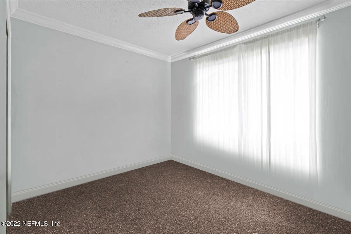 700 West Pope Road, Unit C20 St. Augustine, FL 32080 - Photo 11 of 15 an empty room with a window and a fan