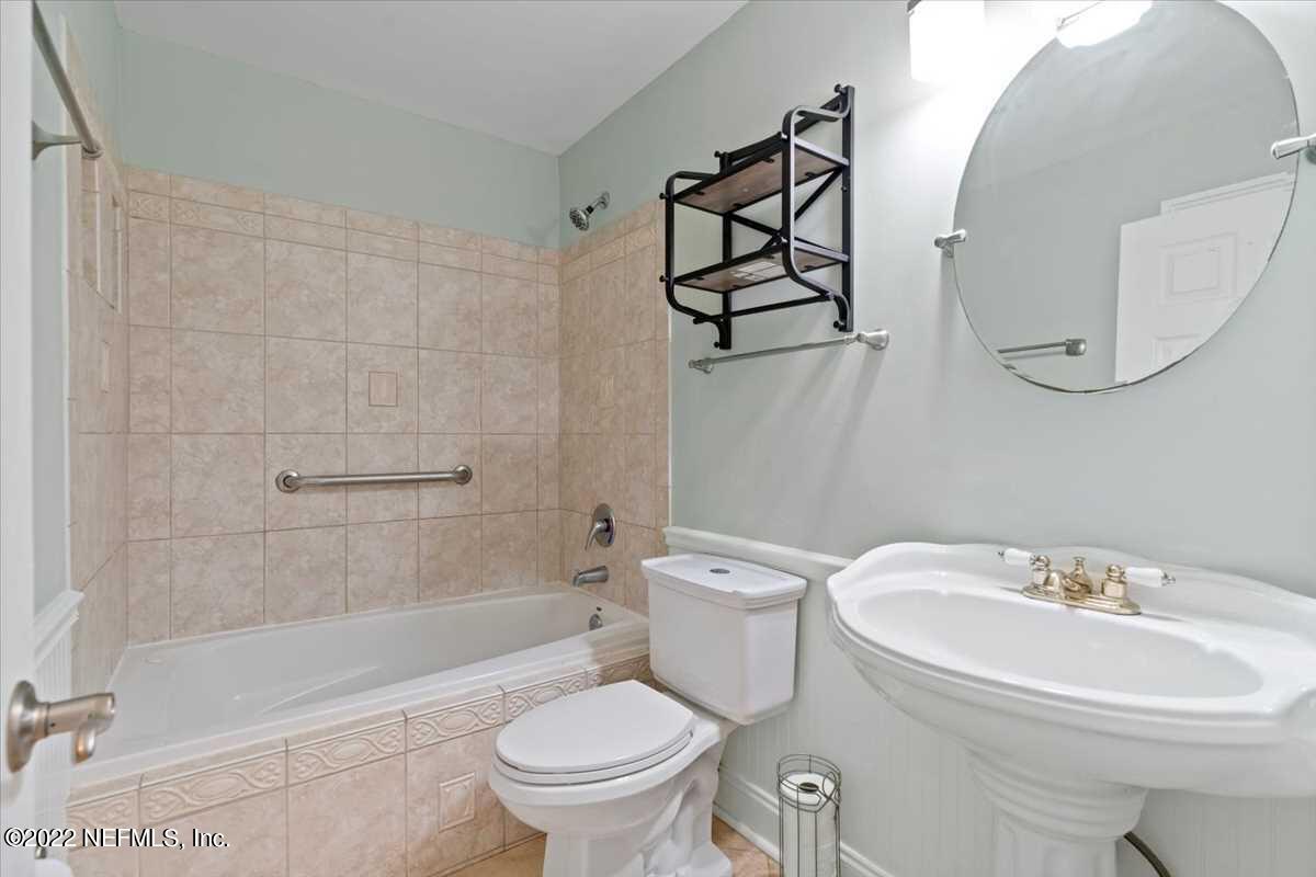 700 West Pope Road, Unit C20 St. Augustine, FL 32080 - Photo 12 of 15 a white toilet sitting next to a bathroom sink and a shower