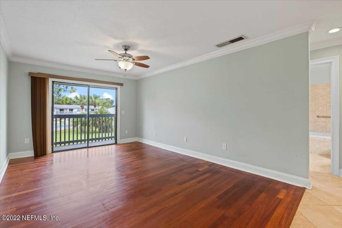 700 West Pope Road, Unit C20 St. Augustine, FL 32080 - Photo 4 of 15 wooden floor in an empty room with a window