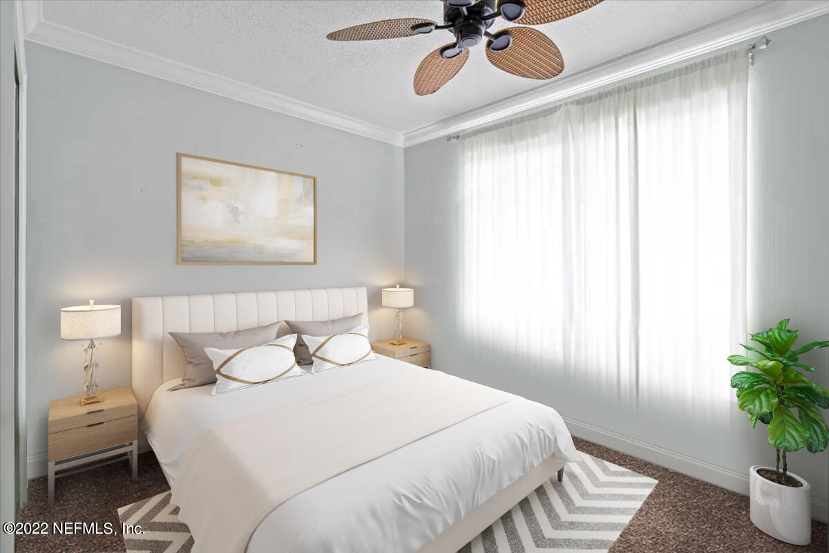 700 West Pope Road, Unit C20 St. Augustine, FL 32080 - Photo 10 of 15 a bedroom with a bed and a potted plant