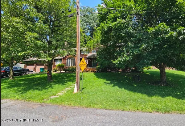 a view of a house with a backyard