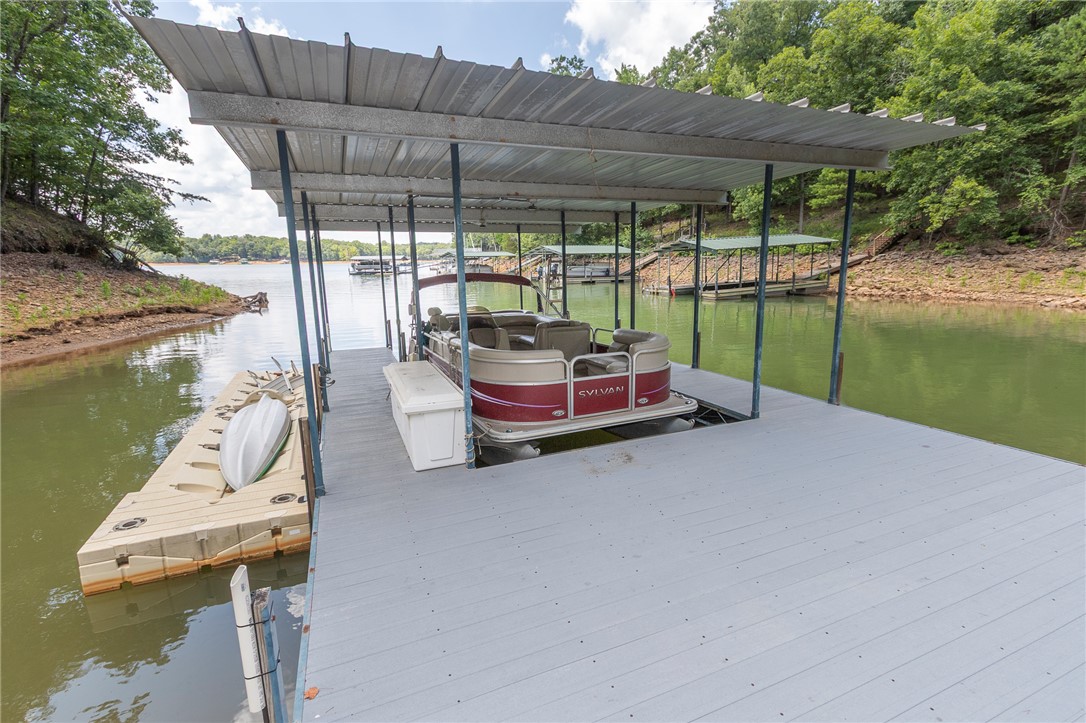 125 Inlet Pointe Drive Anderson, SC 29625 - Photo 6 of 39 A private covered boat dock provides direct access to serene waters, ideal for aquatic leisure.