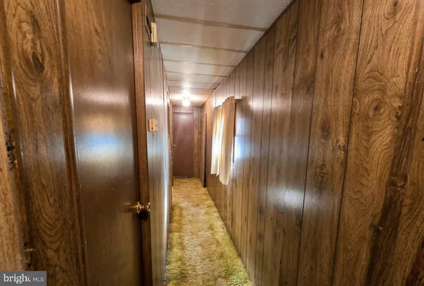 a spacious bedroom with a bed a dresser and a shower