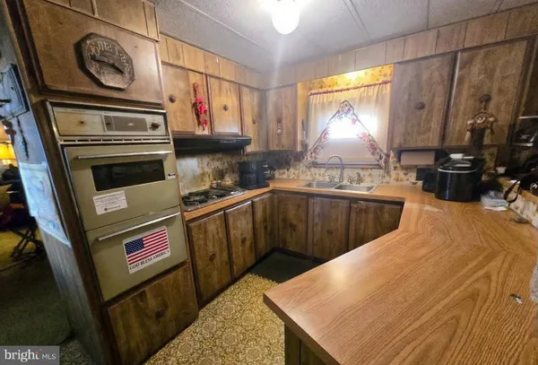 a kitchen with stainless steel appliances a stove a sink and a refrigerator