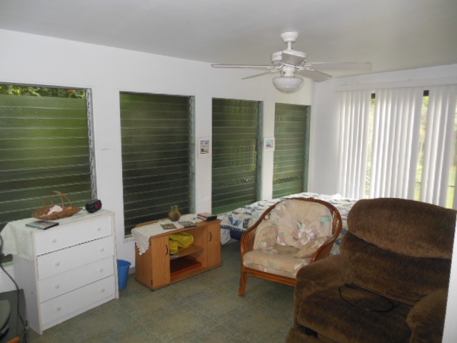 705 Haiku Road Haiku, HI 96708 - Photo 22 of 22 a bedroom with a bed and window
