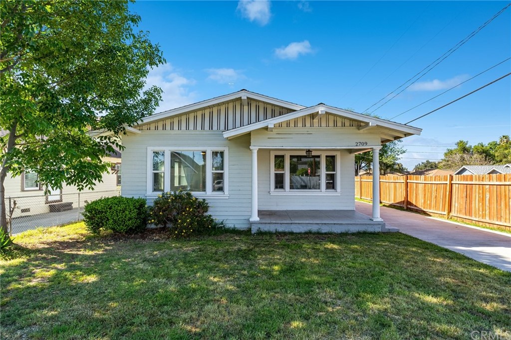 2709 Lime Street Riverside, CA 92501 - Photo 1 of 1 a front view of a house with a yard