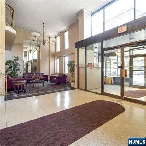 a large room with pool table and windows