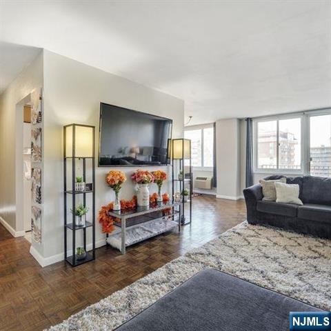160 Overlook Avenue, Unit 18D Hackensack, NJ 07601 - Photo 3 of 14 a living room with furniture and a flat screen tv