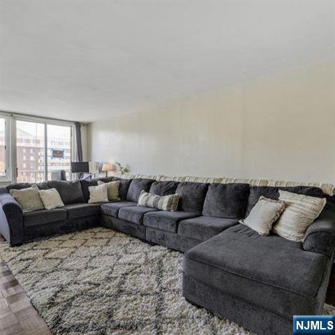 160 Overlook Avenue, Unit 18D Hackensack, NJ 07601 - Photo 4 of 14 a living room with furniture and a large window