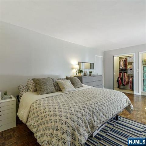 160 Overlook Avenue, Unit 18D Hackensack, NJ 07601 - Photo 7 of 14 a bedroom with a large bed and a couch