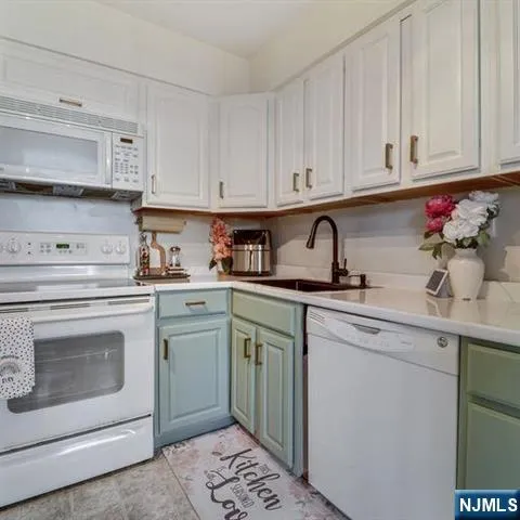 a kitchen with cabinets appliances and a sink