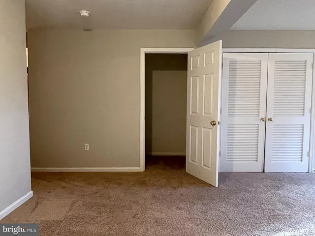 a view of a hallway with wooden floor and entryway