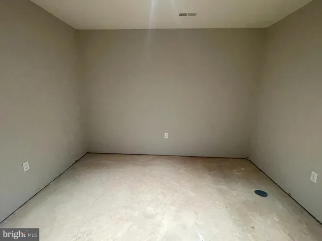 an empty room with a empty space and windows