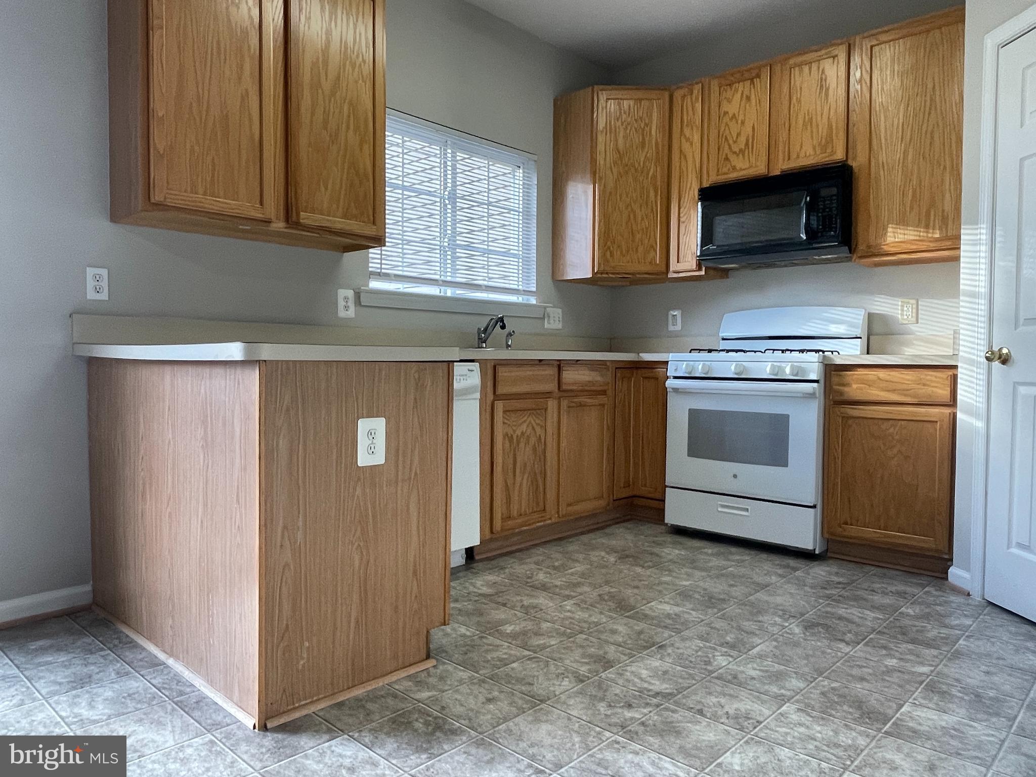 27 Townes Place Fredericksburg, VA 22405 - Photo 19 of 34 a kitchen with granite countertop white cabinets stainless steel appliances and a window