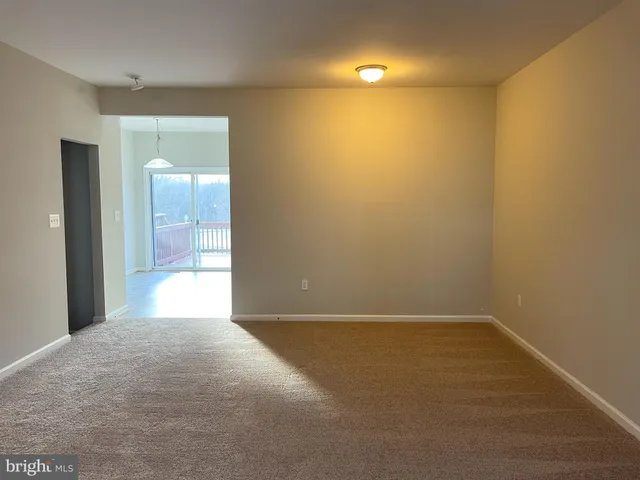 a view of a room with a sink and cabinets