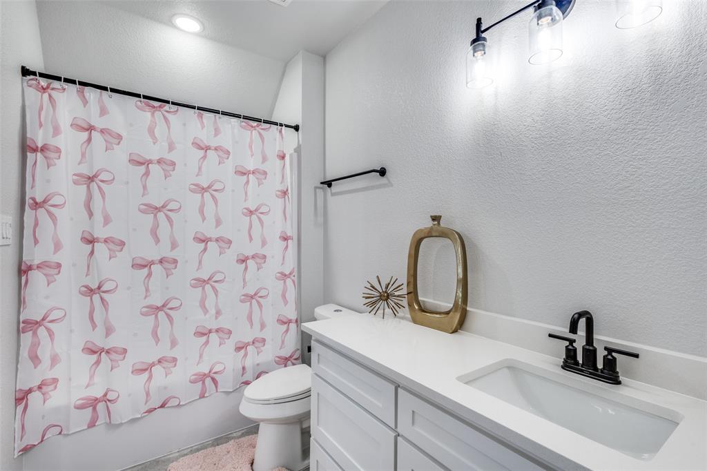 2255 County Road 377 Van Alstyne, TX 75495 - Photo 22 of 35 a bathroom with a sink and a toilet