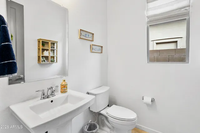 a white toilet sitting next to a bathroom sink