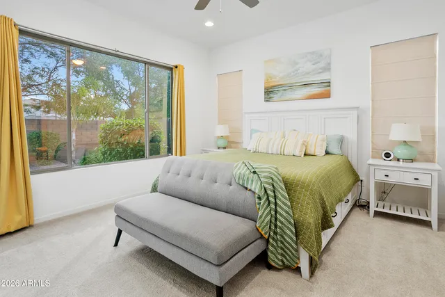 a bedroom with a bed and a large window