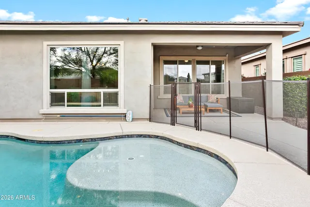 a swimming pool with outdoor seating and yard