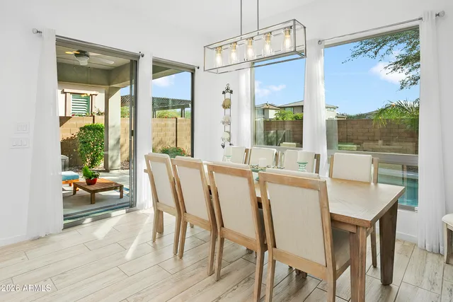 a view of a dining room with furniture large windows and wooden floor