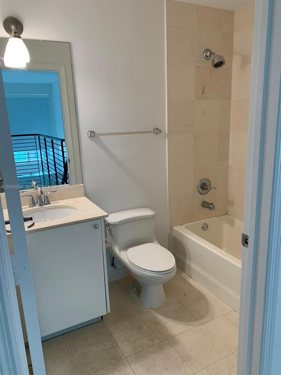 60 Southwest 13th Street, Unit 3202 Miami, FL 33130 - Photo 8 of 13 a bathroom with a sink a toilet and shower