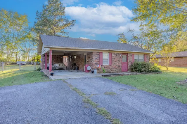 a view of a house with backyard and porch