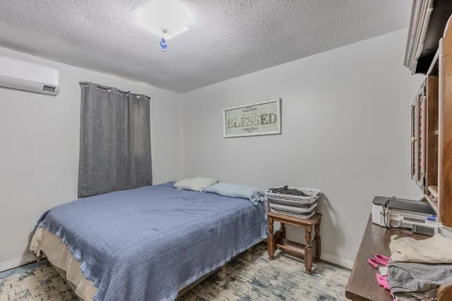 a bedroom with a bed and a dresser in it