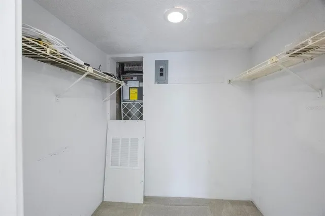 a view of an empty room with closet and a window