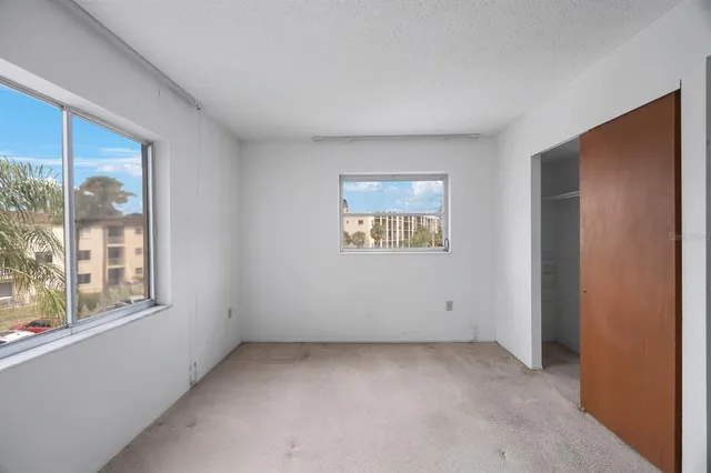 an empty room with closet area