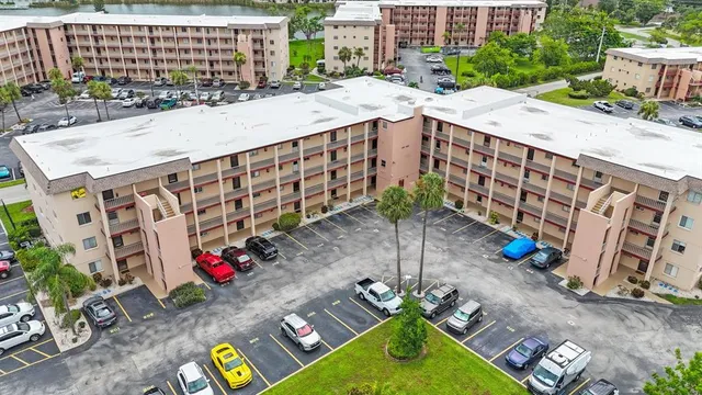 an aerial view of a house with outdoor space and seating area
