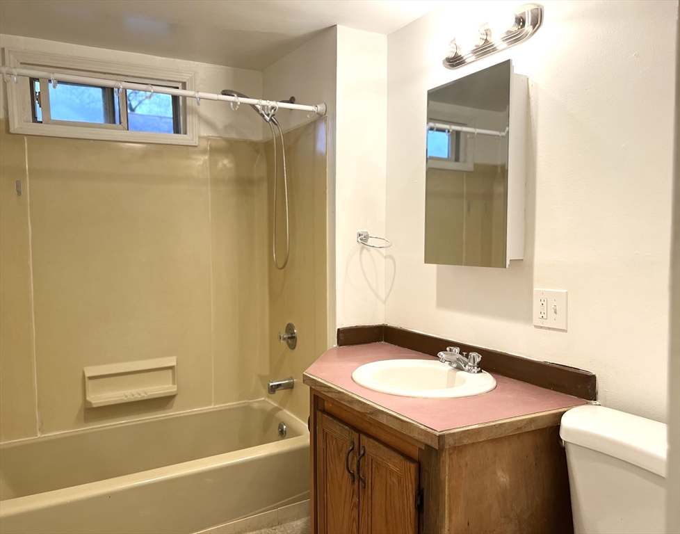 47 Lansing Place, Unit 1 Springfield, MA 01108 - Photo 4 of 10 a bathroom with a granite countertop sink toilet and shower