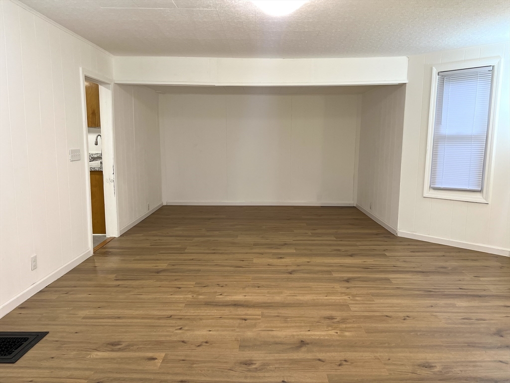 47 Lansing Place, Unit 1 Springfield, MA 01108 - Photo 5 of 10 a view of an empty room with wooden floor and a window