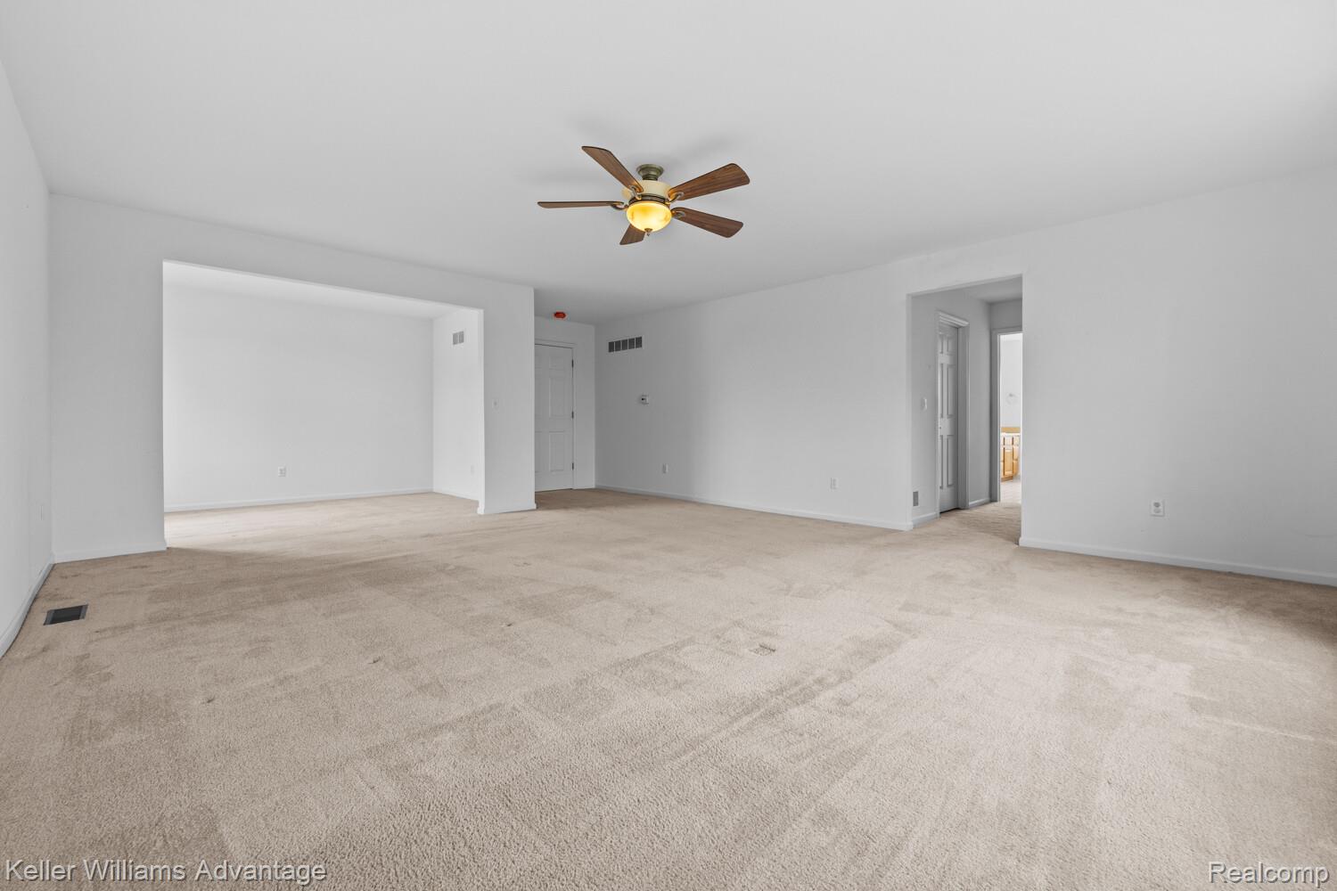 4100 Norwich Court Rochester, MI 48306 - Photo 33 of 72 Unfurnished living room with light carpet and a ceiling fan