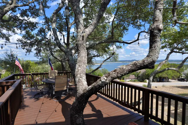 a view of balcony with wooden floor and fence