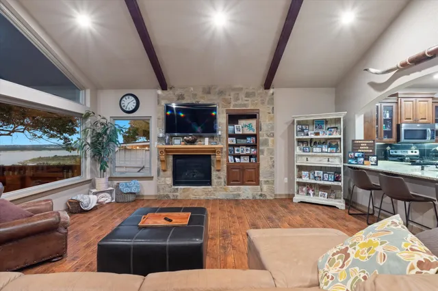 a living room with furniture a flat screen tv and a fireplace