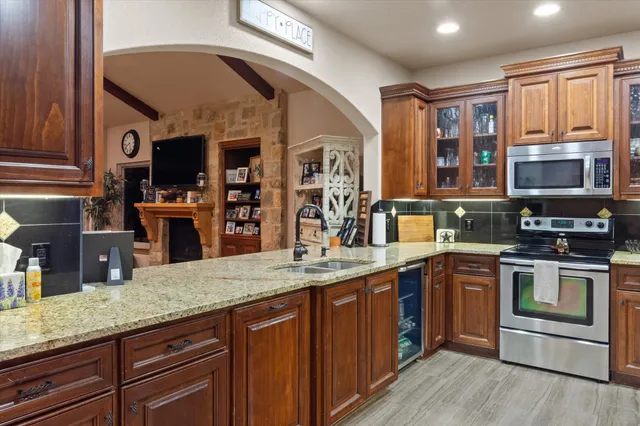 a kitchen with stainless steel appliances granite countertop a stove and a sink