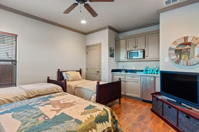 a bedroom with two beds and a flat screen tv