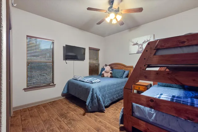 a bedroom with a bed and wooden floor