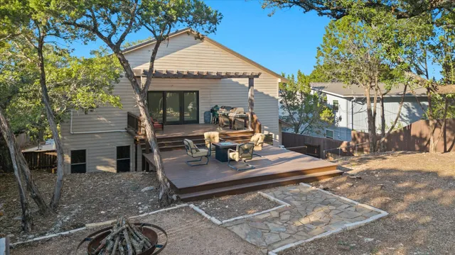 a view of a house with backyard porch and sitting area