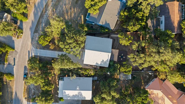 an aerial view of a house with a yard