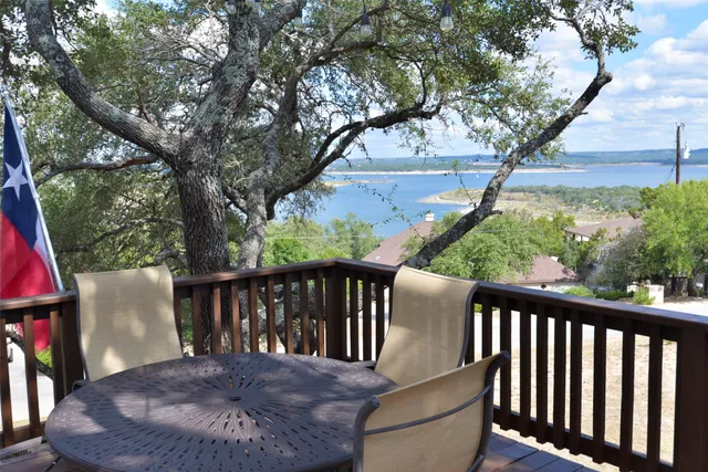 a view of balcony with wooden floor and outdoor seating