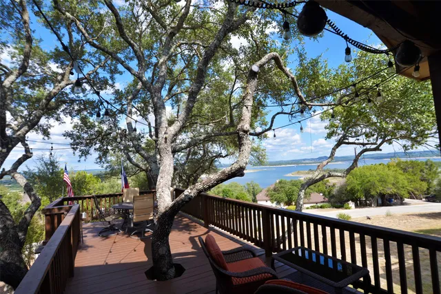 a view of balcony with wooden floor and outdoor seating