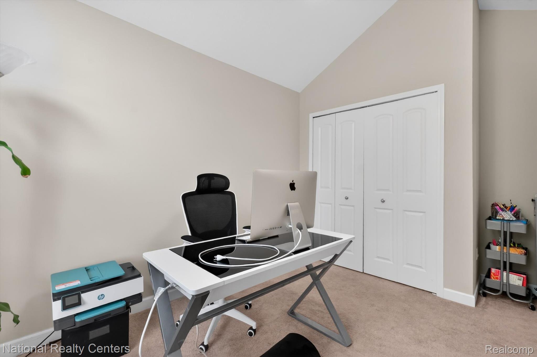 27412 Victoria Road Novi, MI 48374 - Photo 33 of 61 Neutral tone walls with an angled ceiling line, carpeted flooring, and a two-panel bifold closet door