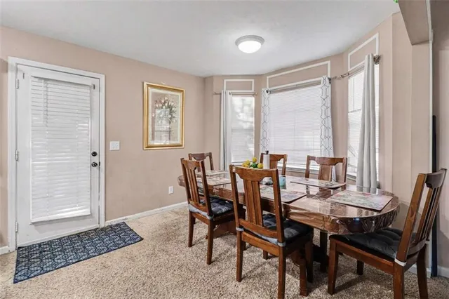 a view of a dining room with furniture and window