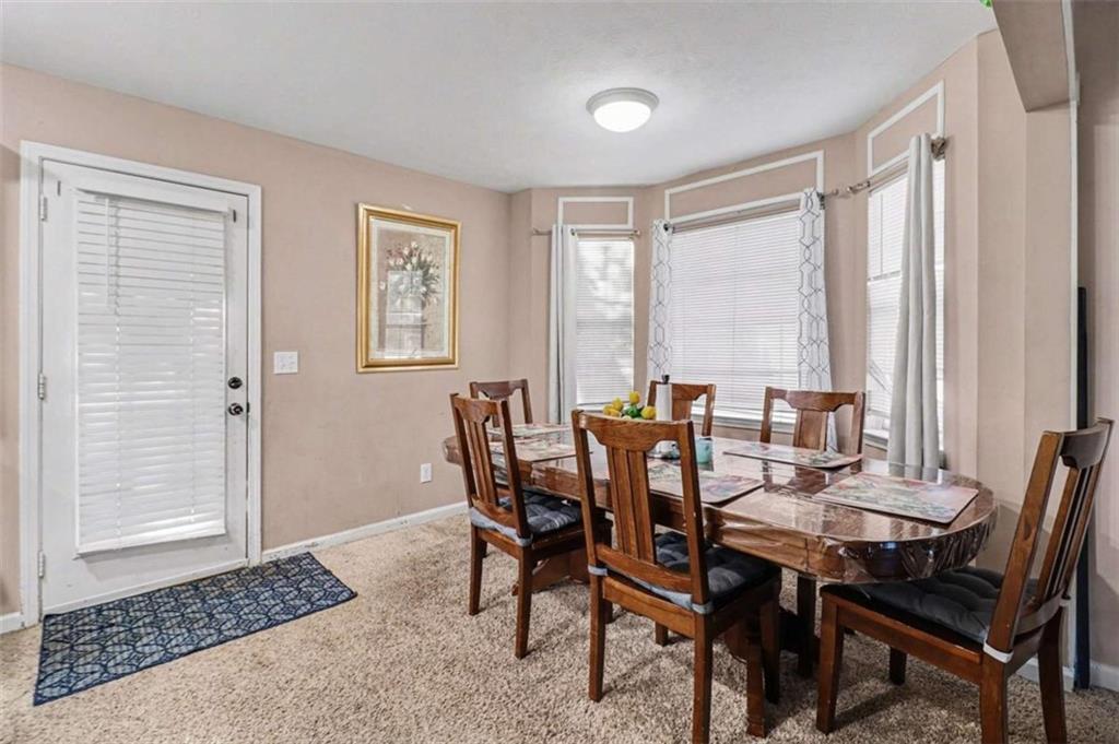 211 Stoney Point Cove Carrollton, GA 30116 - Photo 12 of 38 a view of a dining room with furniture and window
