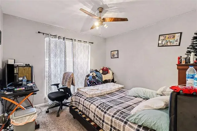 a bedroom that has a bed and a chair in it