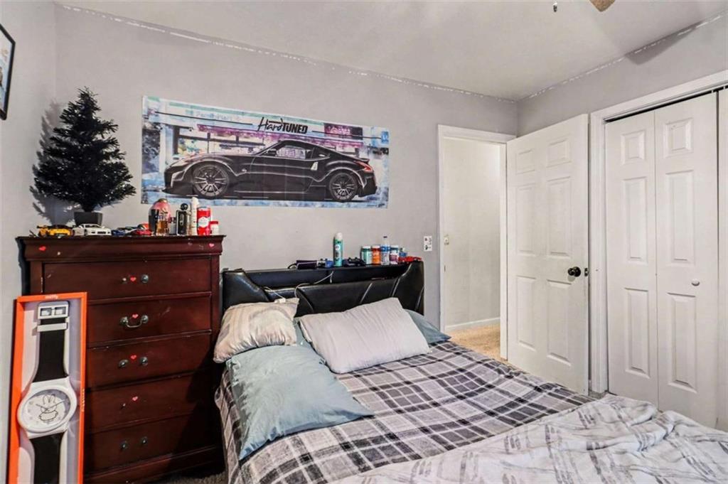 211 Stoney Point Cove Carrollton, GA 30116 - Photo 19 of 38 a bedroom with a bed and a dresser