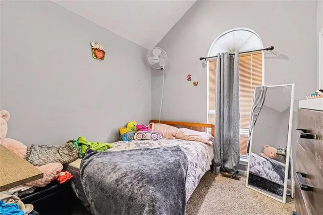 a bedroom with bed and a window