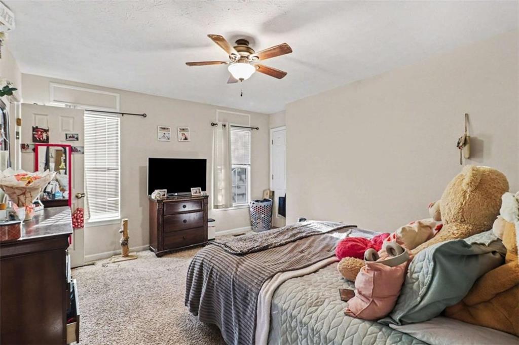 211 Stoney Point Cove Carrollton, GA 30116 - Photo 22 of 38 a bedroom with a bed and a flat screen tv